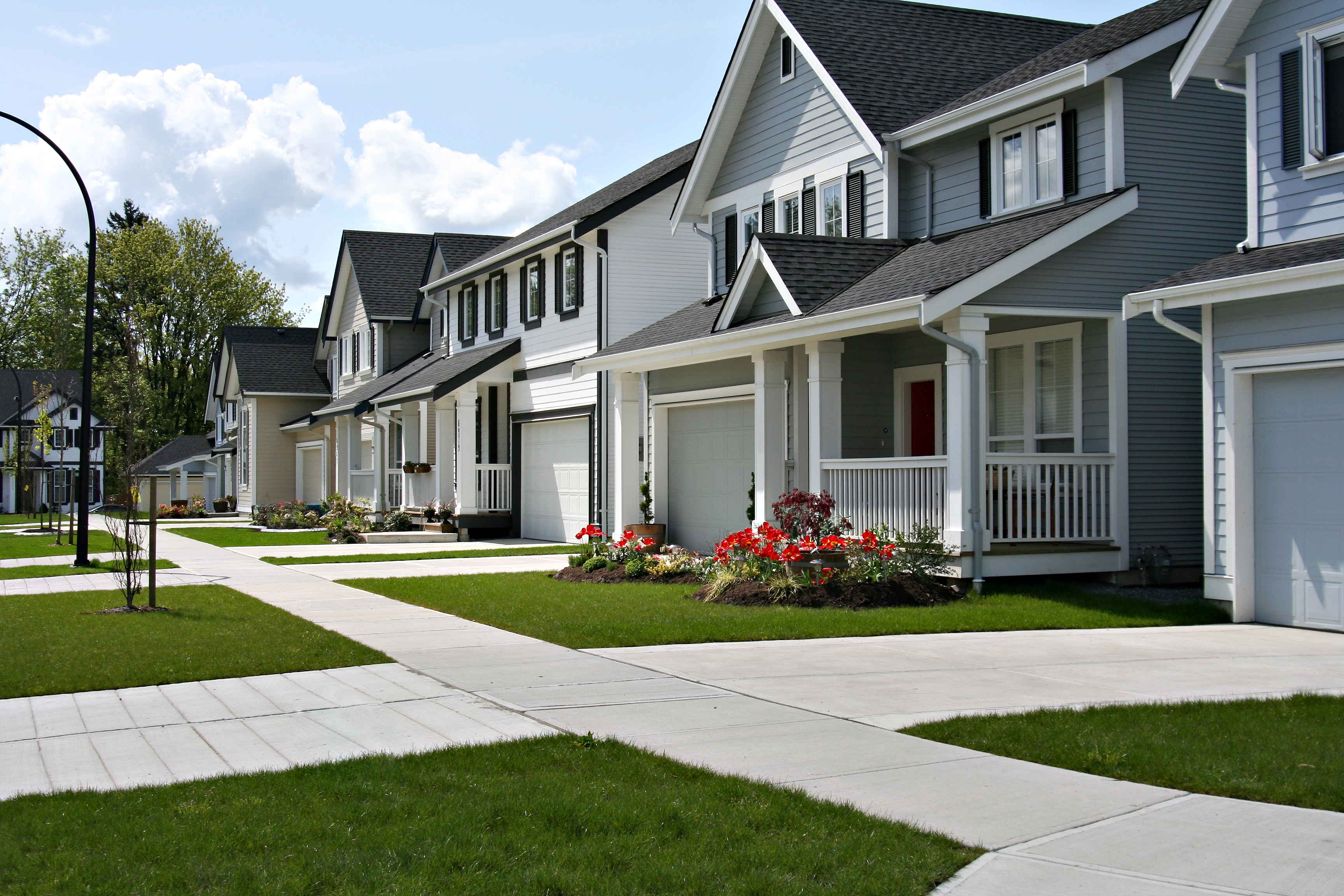 Small town residential street of new town homes with beautiful landscaping after seasonal cleanups